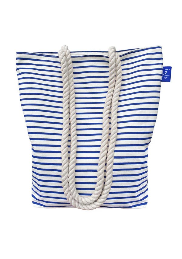 Inis navy and white fine-striped canvas beach bag with thick rope handles and blue Inis branded tag, on white background