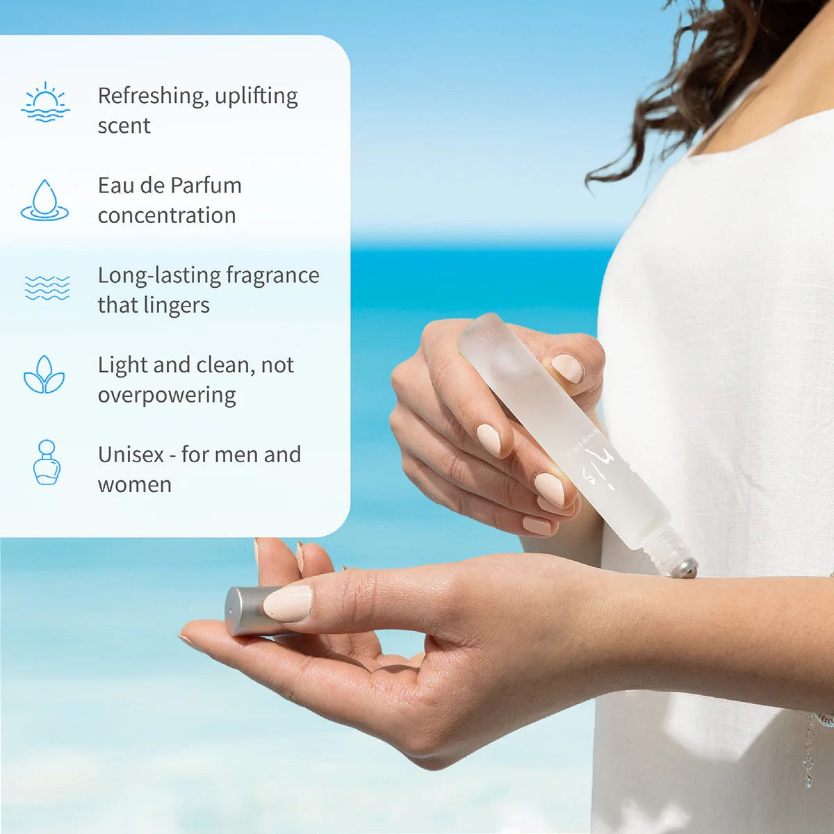 Woman applying Inis roll-on fragrance at the beach with feature list: refreshing uplifting scent, Eau de Parfum concentration, long-lasting, light and clean, unisex